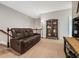 Bonus room features a comfortable leather couch with a sleek black bookcase at 3557 Ashcroft Se Dr, Smyrna, GA 30080