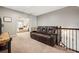 Upstairs bonus room boasts a comfy leather couch and access to the main bedroom at 3557 Ashcroft Se Dr, Smyrna, GA 30080