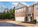 Beautiful brick townhome showcasing a well-maintained front yard and a two-car garage at 3557 Ashcroft Se Dr, Smyrna, GA 30080