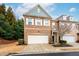 Charming brick townhome with a two-car garage and manicured landscaping on a beautiful day at 3557 Ashcroft Se Dr, Smyrna, GA 30080