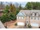 Townhome featuring a brick facade, two-car garage, and well-maintained landscaping at 3557 Ashcroft Se Dr, Smyrna, GA 30080