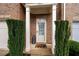 Close-up of the front door, framed by manicured greenery and elegant pillars at 3557 Ashcroft Se Dr, Smyrna, GA 30080