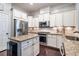 Bright kitchen featuring stainless steel appliances, granite counters, and ample cabinet space at 3557 Ashcroft Se Dr, Smyrna, GA 30080