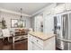 Well-lit dining area with stainless steel fridge and island with granite countertop at 3557 Ashcroft Se Dr, Smyrna, GA 30080