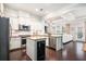 Open concept kitchen with granite countertops, stainless steel appliances, and seamless flow to living area at 3557 Ashcroft Se Dr, Smyrna, GA 30080