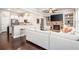 Open concept living room flows to the kitchen, featuring a fireplace, built-in shelves, and modern finishes at 3557 Ashcroft Se Dr, Smyrna, GA 30080