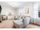 Bright living room with large windows and a comfortable gray sectional sofa at 3557 Ashcroft Se Dr, Smyrna, GA 30080
