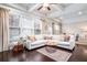 Bright and airy living room featuring coffered ceilings, large windows, and hardwood flooring with stylish rug at 3557 Ashcroft Se Dr, Smyrna, GA 30080