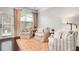 Cozy living room showcasing three armchairs, natural light, and hardwood floors with a textured area rug at 3557 Ashcroft Se Dr, Smyrna, GA 30080