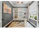 Bright home office features custom built-in shelving, a large window, and a neutral color scheme at 3557 Ashcroft Se Dr, Smyrna, GA 30080
