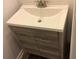 Modern bathroom vanity with a white sink and sleek gray wood grain cabinetry at 1466 Andrews Nw St, Atlanta, GA 30314