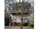 Two-story home featuring double balconies, a neutral exterior, and natural surroundings at 1466 Andrews Nw St, Atlanta, GA 30314