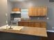 Charming kitchen with tile backsplash, warm wood cabinets, and a granite countertop island at 1466 Andrews Nw St, Atlanta, GA 30314
