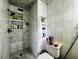 Bathroom featuring white tiling, multiple storage niches and neutral tones at 3356 Hollow Ct, Lawrenceville, GA 30044