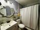 Charming bathroom with tiled walls, modern vanity, updated fixtures, and a shower-tub combination with a curtain at 3356 Hollow Ct, Lawrenceville, GA 30044