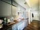 Well-lit kitchen featuring modern appliances, gray cabinets, hardwood floors, and functional layout for cooking and dining at 3356 Hollow Ct, Lawrenceville, GA 30044