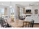 Bright dining room with a large wooden table, modern chandelier, and ample natural light at 3539 Cedarvale Ct, Powder Springs, GA 30127