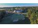 Aerial view of the property showcasing the golf course, clubhouse, and surrounding trees at 583 Carl Sanders Dr, Acworth, GA 30101