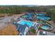 Aerial view of community amenities with pool, lazy river, clubhouse, tennis courts, and scenic surroundings at 583 Carl Sanders Dr, Acworth, GA 30101