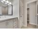 Bright bathroom featuring a white vanity with drawers and a closet, providing ample storage at 583 Carl Sanders Dr, Acworth, GA 30101