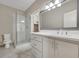 Bright bathroom featuring a white vanity, walk-in shower, and a closet for ample storage at 583 Carl Sanders Dr, Acworth, GA 30101