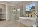 Stunning bathroom showcasing a modern shower, soaking tub, and a large window for natural light at 583 Carl Sanders Dr, Acworth, GA 30101