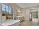 Bright bathroom featuring a soaking tub, large window, and a stylish vanity with modern fixtures at 583 Carl Sanders Dr, Acworth, GA 30101