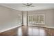 Bright bedroom featuring hardwood floors, a ceiling fan, and large windows overlooking a lush landscape at 583 Carl Sanders Dr, Acworth, GA 30101