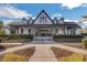 Elegant clubhouse entrance with manicured landscaping and inviting covered porch seating area at 583 Carl Sanders Dr, Acworth, GA 30101