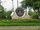 Stone sign at Governors Towne Club entrance with manicured lawn, greenery and beautiful flowers at 583 Carl Sanders Dr, Acworth, GA 30101