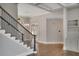 Bright foyer featuring hardwood floors, a staircase with iron railing, and a decorative chandelier at 583 Carl Sanders Dr, Acworth, GA 30101