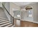 Elegant foyer with hardwood floors, grand staircase, and a decorative chandelier at 583 Carl Sanders Dr, Acworth, GA 30101