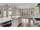 Bright kitchen features a spacious island, stainless appliances, custom cabinets, and hardwood flooring at 583 Carl Sanders Dr, Acworth, GA 30101
