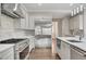 Gourmet kitchen featuring stainless steel appliances, a large island, and bright open floor plan at 583 Carl Sanders Dr, Acworth, GA 30101