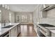 Modern kitchen with stainless steel appliances, island with sink, and view to the outdoor living space at 583 Carl Sanders Dr, Acworth, GA 30101