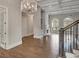 Bright living room with coffered ceiling, large arched windows, hardwood floors and elegant chandelier at 583 Carl Sanders Dr, Acworth, GA 30101