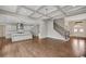 Open-concept living space featuring hardwood floors, chef's kitchen, coffered ceiling and staircase at 583 Carl Sanders Dr, Acworth, GA 30101