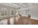 Open-concept living room with hardwood floors, coffered ceilings, fireplace and view into the bright kitchen at 583 Carl Sanders Dr, Acworth, GA 30101