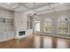 Spacious living room featuring coffered ceiling, a fireplace with built-in shelving, and gleaming hardwood floors at 583 Carl Sanders Dr, Acworth, GA 30101
