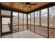 Enclosed porch featuring vaulted wood ceilings, tile floors, and black metal railings at 583 Carl Sanders Dr, Acworth, GA 30101