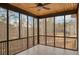 View of the enclosed porch with wooden ceiling and black metal railings overlooking the landscape at 583 Carl Sanders Dr, Acworth, GA 30101