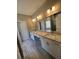 Bathroom featuring double sinks, granite countertops, and modern fixtures at 183 Brookwood Xing, Douglasville, GA 30134
