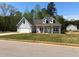 Charming single-story home boasts a well-manicured lawn and an attached two-car garage at 183 Brookwood Xing, Douglasville, GA 30134