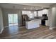 Modern kitchen with white cabinets, granite countertops, stainless steel appliances, and wood-look flooring at 183 Brookwood Xing, Douglasville, GA 30134