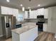 Modern kitchen featuring granite counters, an island, and stainless steel appliances at 183 Brookwood Xing, Douglasville, GA 30134