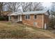 Charming brick home featuring a metal roof and cozy front porch at 1031 Dogwood Pl, Marietta, GA 30062