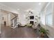 Cozy living room with hardwood floors, a fireplace, built-in shelves, and ample natural light at 1461 Thomas St, Conyers, GA 30094