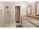 Well-lit bathroom with double sink vanity, stylish fixtures, and glass-enclosed shower for a modern look at 1950 Buford Dam Rd # 105, Cumming, GA 30041