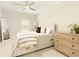 Bright bedroom features a neutral color palette, ceiling fan, and an elegant decorative mirror at 1950 Buford Dam Rd # 105, Cumming, GA 30041