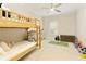 bedroom features a wooden bunk bed, ceiling fan, and a light-filled window at 1950 Buford Dam Rd # 105, Cumming, GA 30041